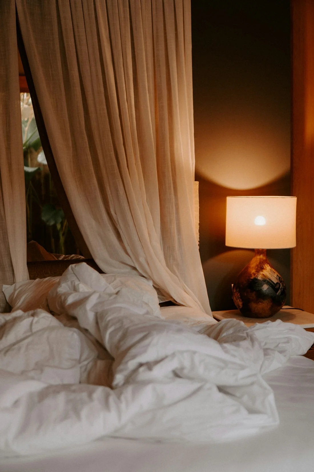 A bedside lamp casting a warm evening glow
